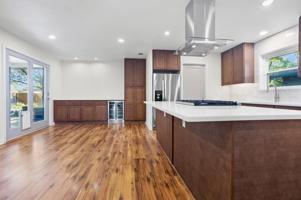 Professional Kitchen and Bathroom Remodeling in Bedford showcasing an open-concept kitchen with a large island, premium finishes, and improved functionality