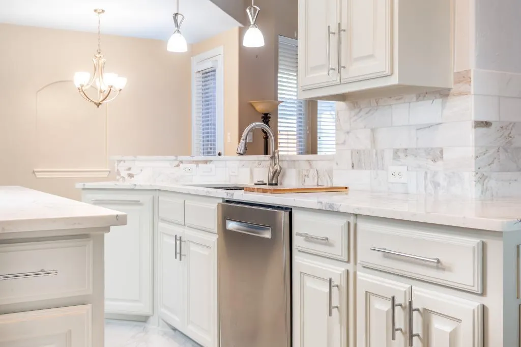 Kitchen Remodel Contractors Colleyville installing custom kitchen cabinets with precision craftsmanship